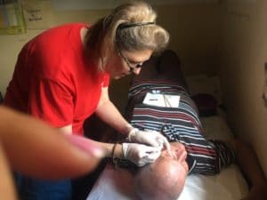 Photo of Mellissa Binney examining a patient in Honduras.