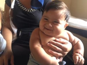 Photo of a Honduran baby smiling.