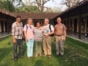 Photo of Mellissa Binney smiling with 4 other people.