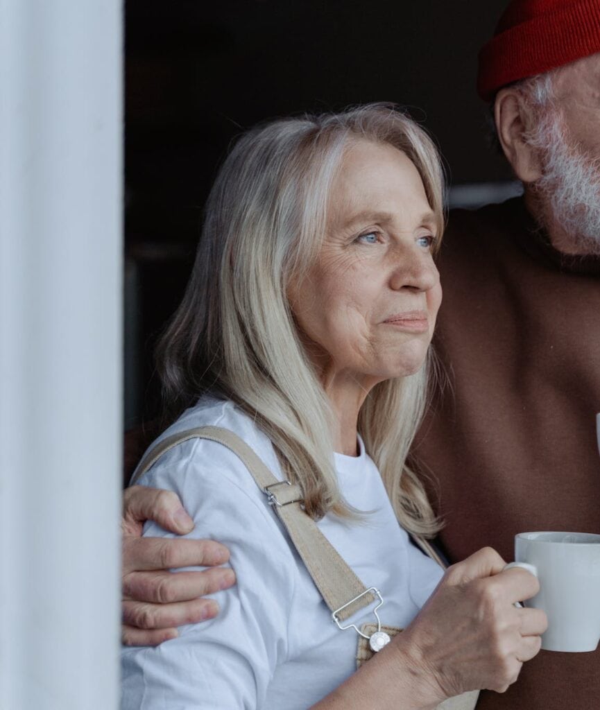 Man and Woman Holding White Ceramic Mugs